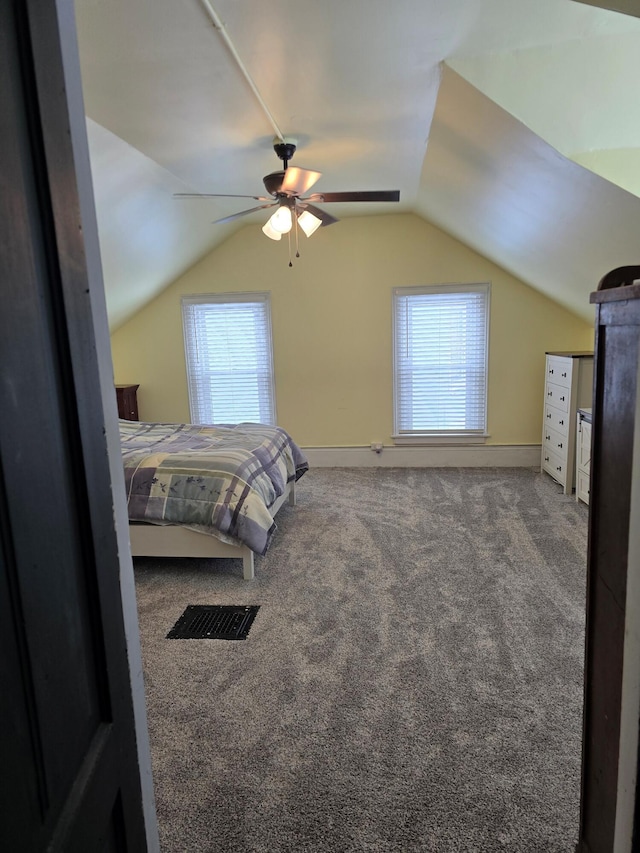 carpeted bedroom with ceiling fan and lofted ceiling