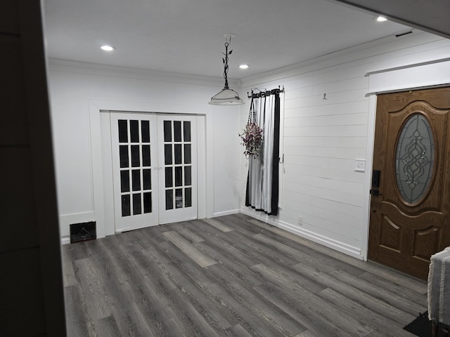 foyer entrance featuring dark hardwood / wood-style flooring, french doors, and ornamental molding