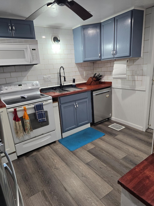 kitchen featuring white appliances, sink, and blue cabinets