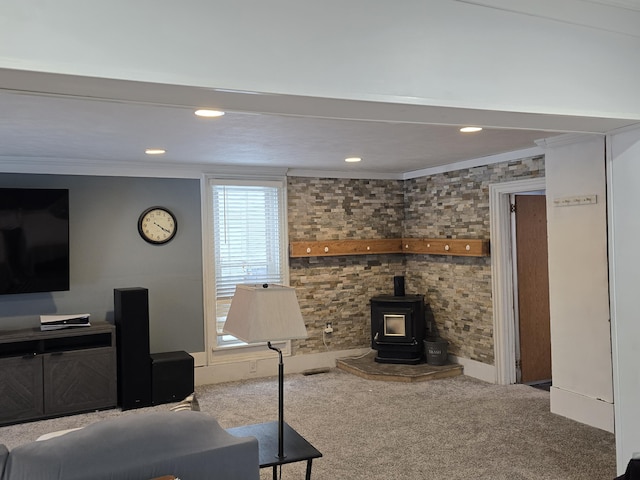 carpeted living room featuring a wood stove and crown molding