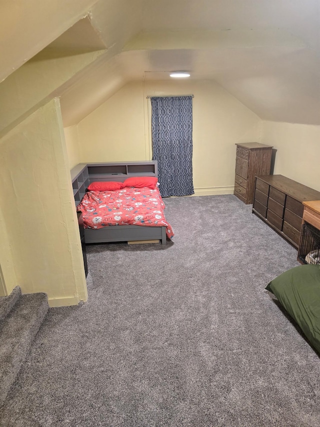 bedroom with carpet flooring and lofted ceiling