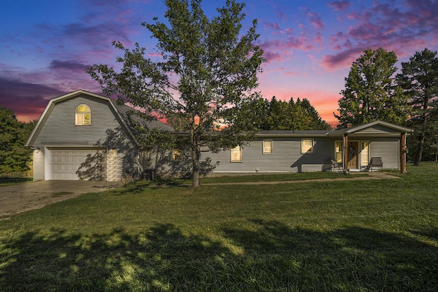 view of front of property featuring a lawn and a garage