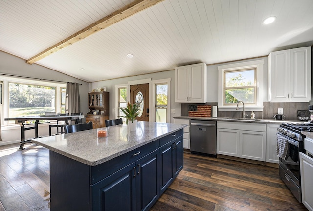 kitchen featuring appliances with stainless steel finishes, wood ceiling, white cabinetry, and a kitchen island