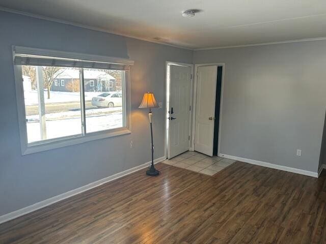 unfurnished room featuring crown molding and dark hardwood / wood-style floors