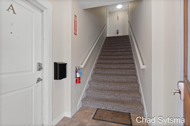 stairs featuring tile patterned floors