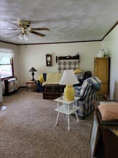 carpeted living room with ceiling fan and crown molding