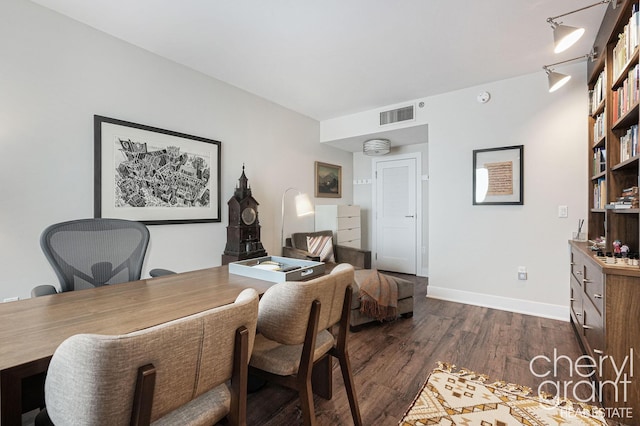 office featuring dark hardwood / wood-style flooring and rail lighting