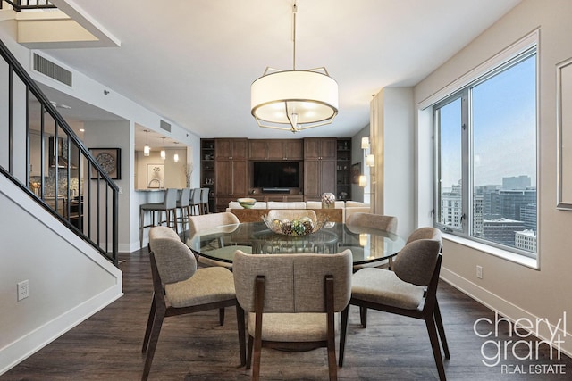 dining room with dark hardwood / wood-style flooring