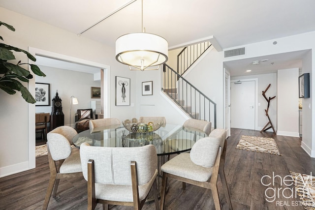 dining space featuring dark wood-type flooring