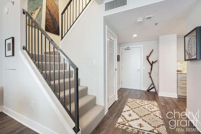 stairs with hardwood / wood-style flooring