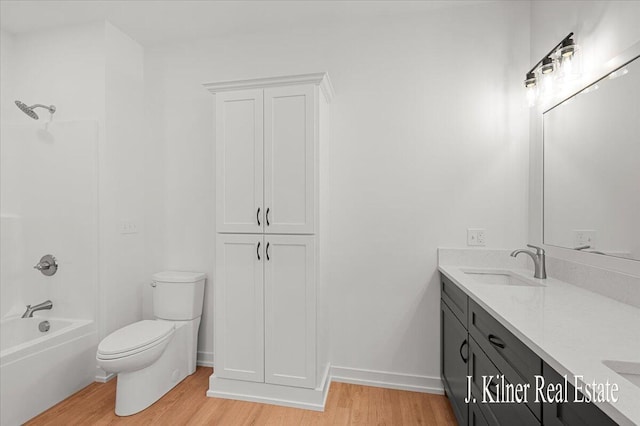 full bathroom featuring vanity, wood-type flooring, shower / tub combination, and toilet