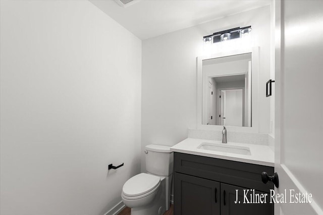 bathroom featuring vanity and toilet