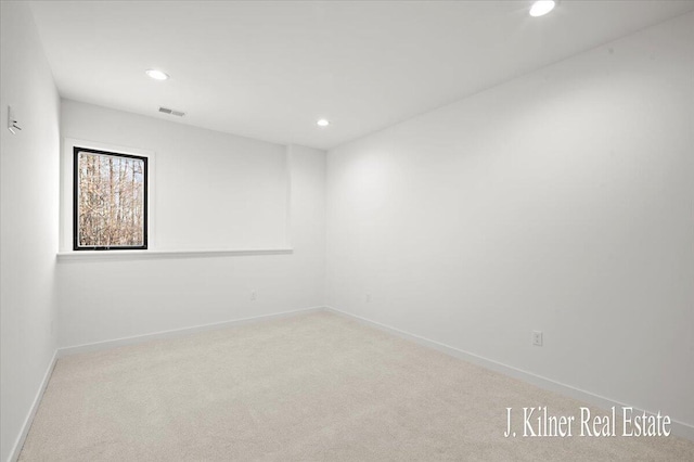 spare room with light colored carpet