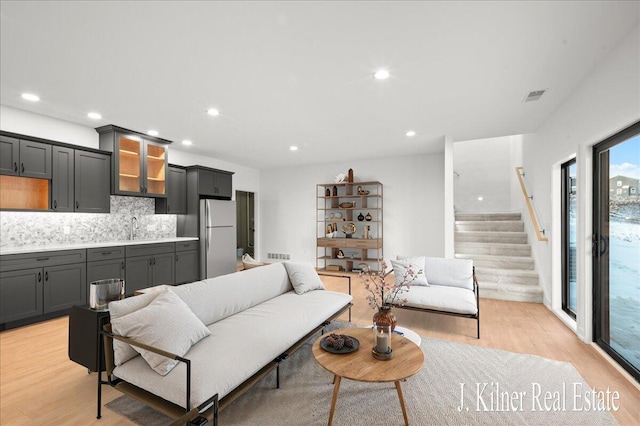 living room featuring sink and light wood-type flooring