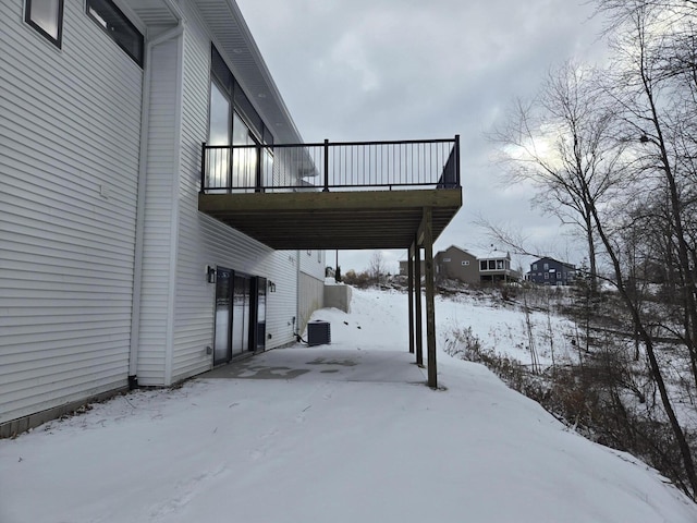 snow covered patio featuring central air condition unit