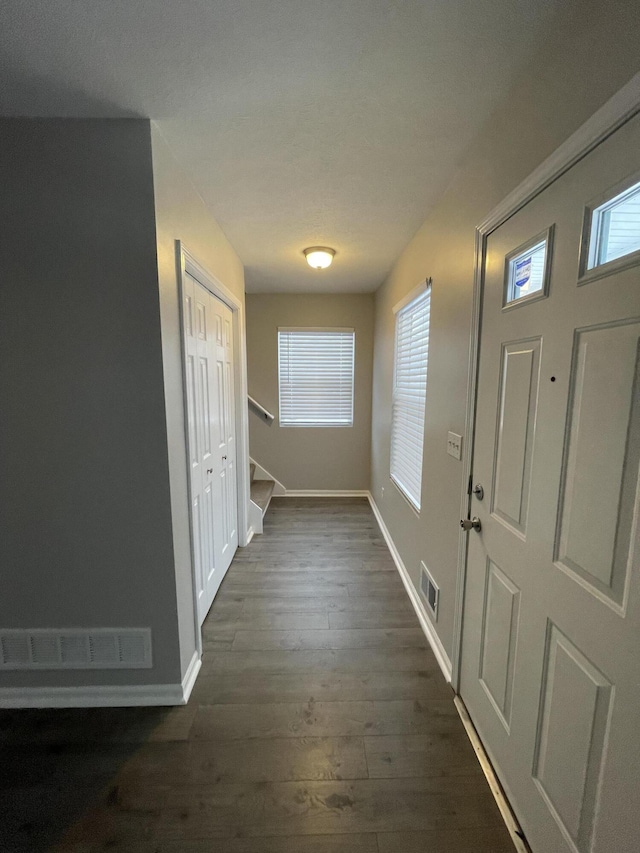 hall with dark wood-type flooring