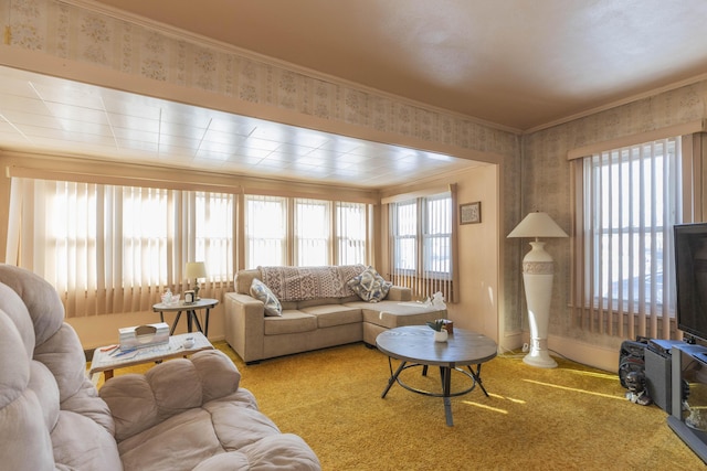 living room with a healthy amount of sunlight, crown molding, and light colored carpet