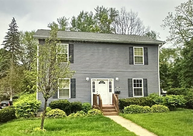 colonial inspired home with a front yard