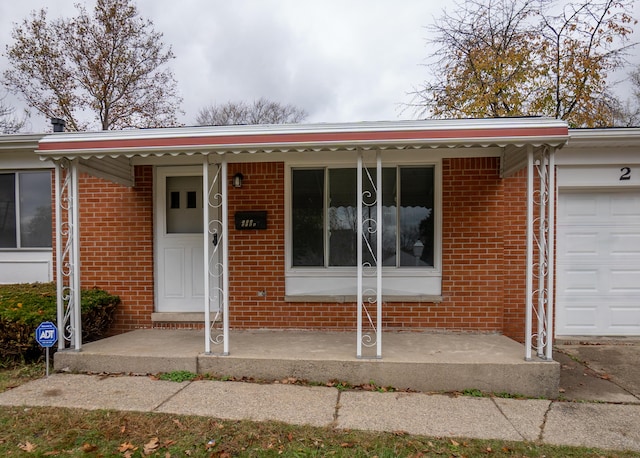 single story home with covered porch and a garage