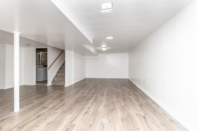 basement with light hardwood / wood-style floors