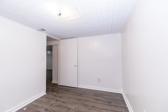 empty room featuring dark wood-type flooring