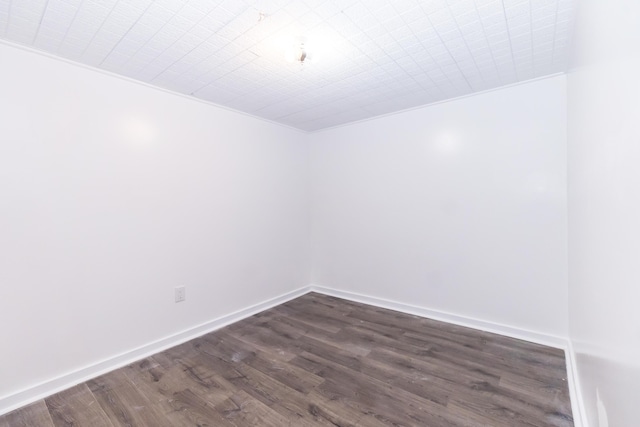 unfurnished room with dark hardwood / wood-style floors