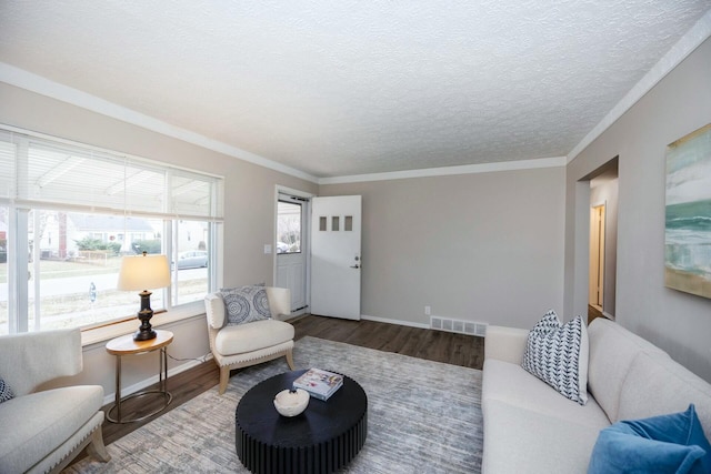 living room featuring a textured ceiling, hardwood / wood-style flooring, and ornamental molding