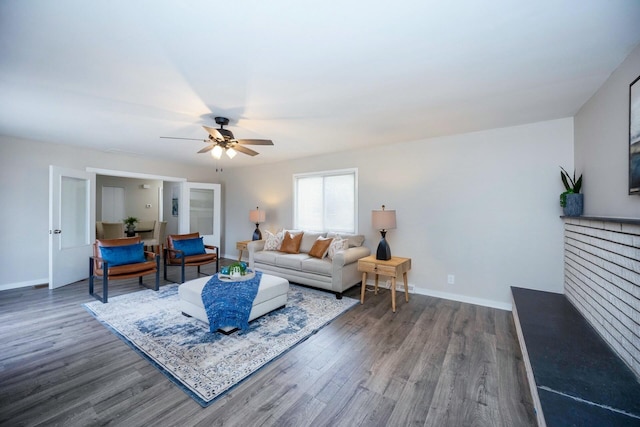 living room with dark hardwood / wood-style flooring and ceiling fan