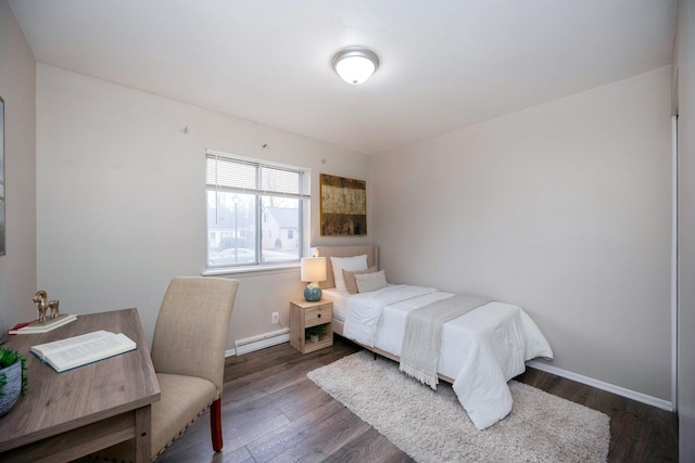 bedroom with dark hardwood / wood-style flooring and a baseboard radiator