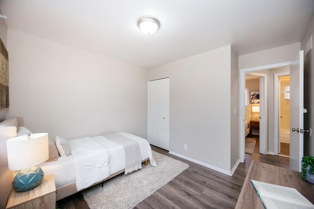 bedroom with a closet and dark hardwood / wood-style floors