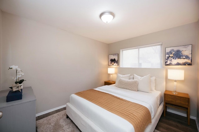 bedroom with dark wood-type flooring