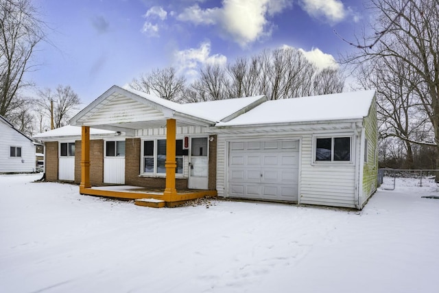 ranch-style house featuring a garage and covered porch