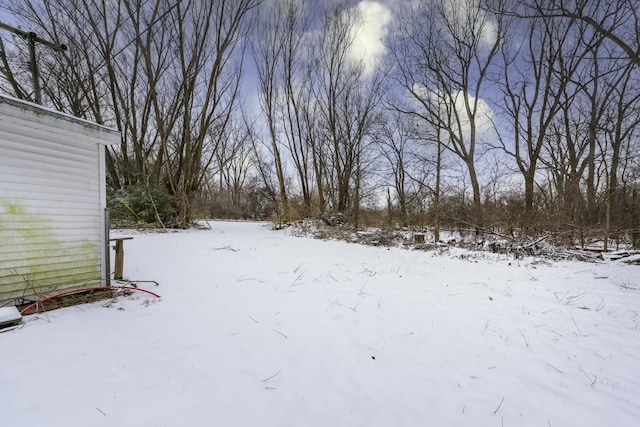 view of yard layered in snow