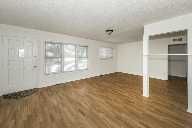 entrance foyer featuring a textured ceiling and hardwood / wood-style floors