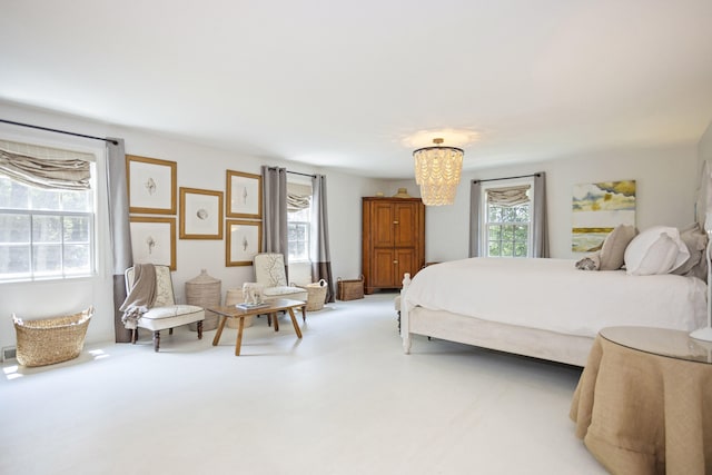 carpeted bedroom featuring an inviting chandelier