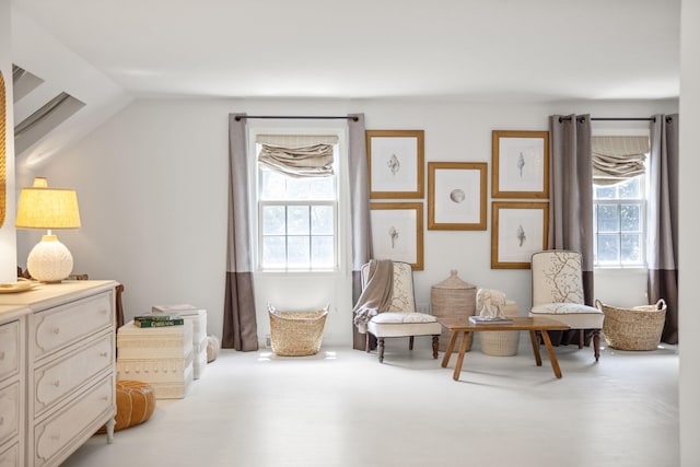 living area with plenty of natural light and vaulted ceiling