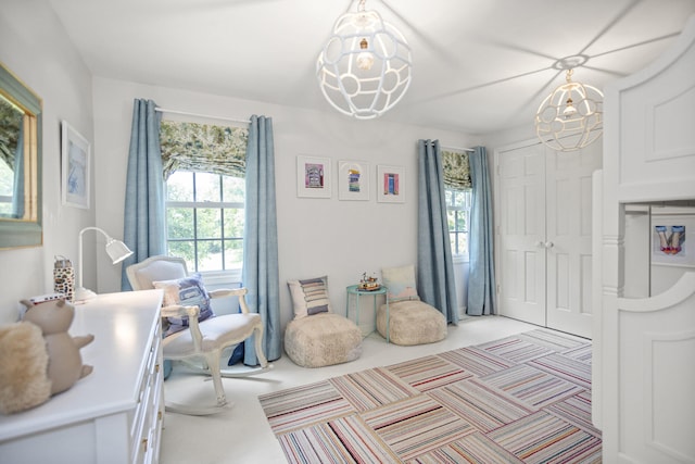 interior space with a notable chandelier and light carpet