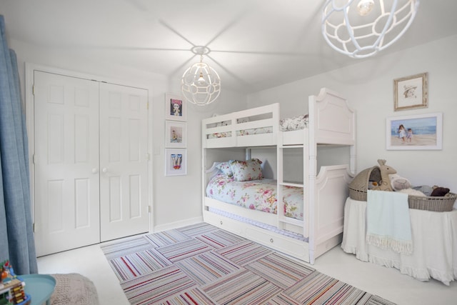 bedroom featuring a closet and a notable chandelier