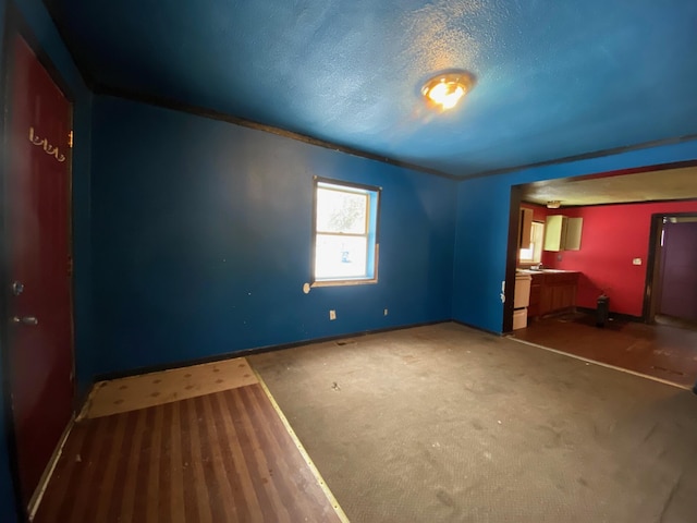 unfurnished bedroom featuring a textured ceiling and dark colored carpet