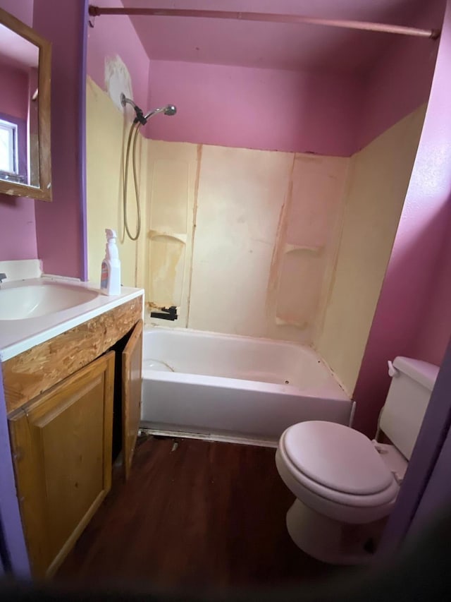 full bathroom featuring bathing tub / shower combination, hardwood / wood-style floors, vanity, and toilet