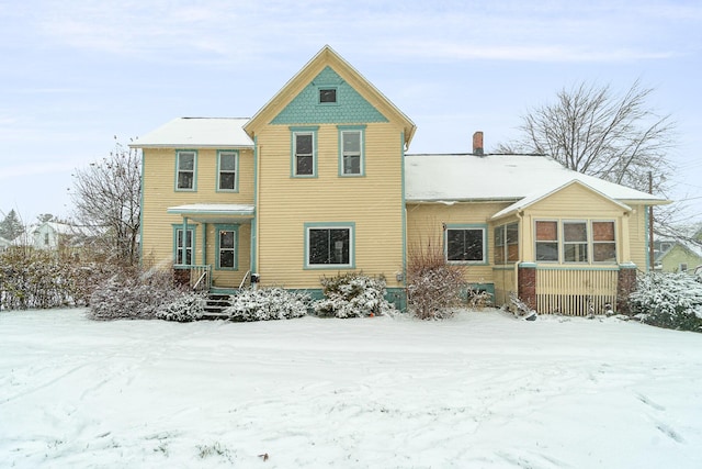 snow covered house with covered porch