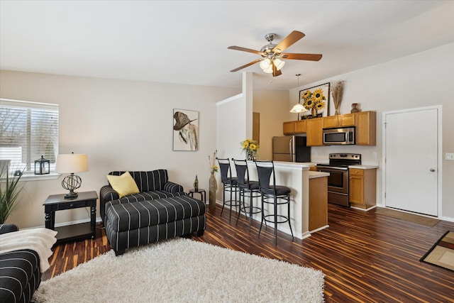 living room featuring ceiling fan and dark hardwood / wood-style flooring