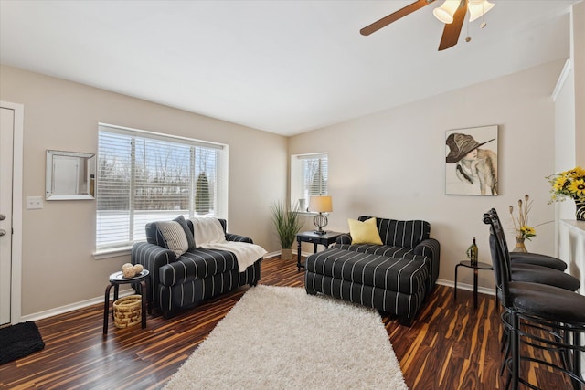 living room featuring ceiling fan and dark wood-type flooring