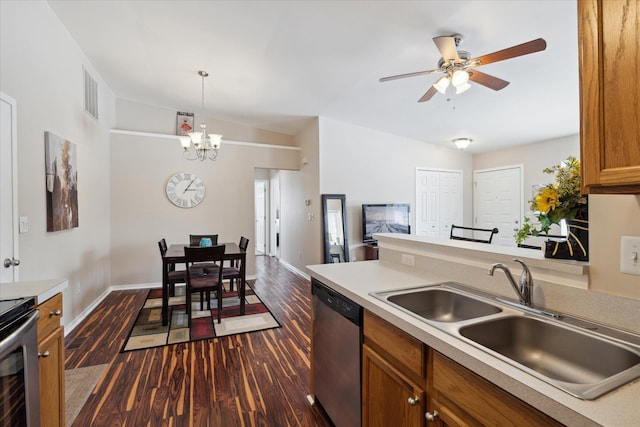 kitchen with appliances with stainless steel finishes, pendant lighting, dark hardwood / wood-style floors, sink, and ceiling fan with notable chandelier