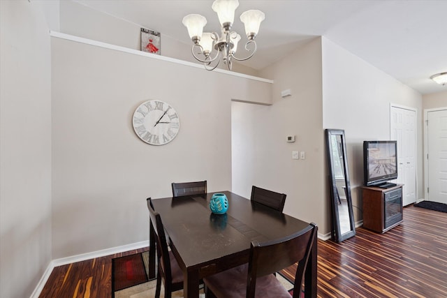 dining room featuring dark hardwood / wood-style flooring and a chandelier