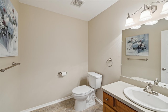 bathroom featuring vanity and toilet