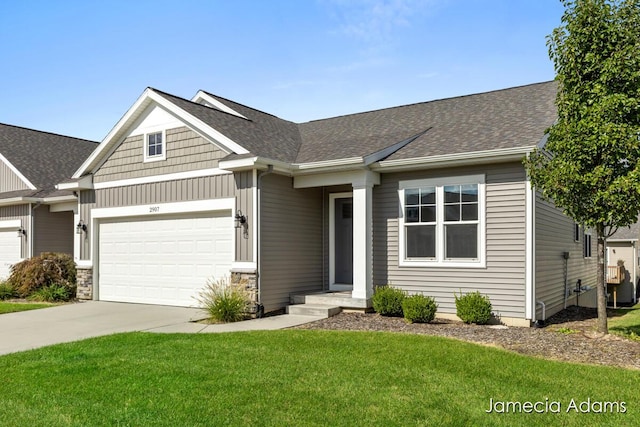 view of front of property featuring a front lawn and a garage