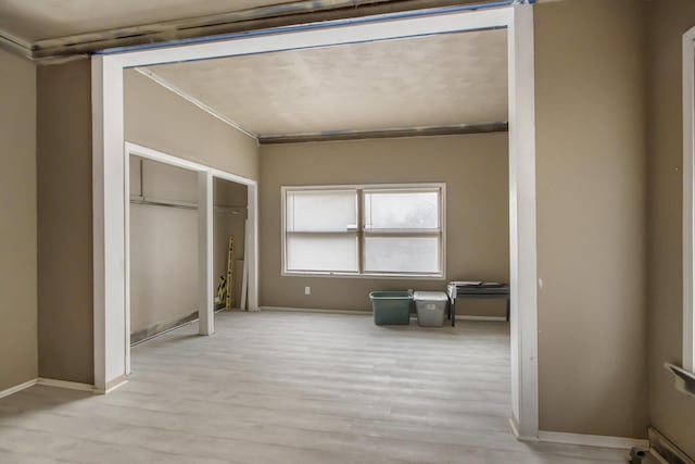 interior space with a closet and light hardwood / wood-style floors