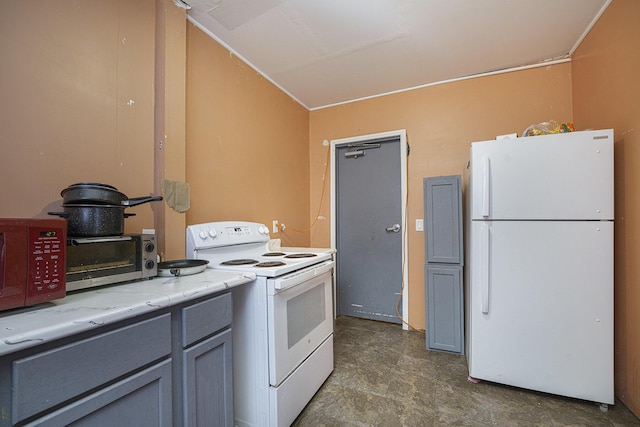 kitchen with white appliances, vaulted ceiling, and gray cabinets