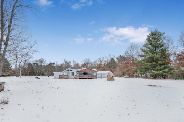 snowy yard with a deck